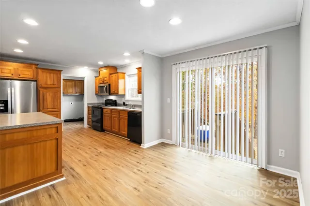 a kitchen with stainless steel appliances granite countertop a refrigerator and a sink