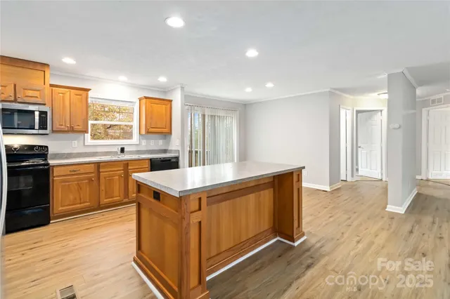 a kitchen with a stove sink and cabinets