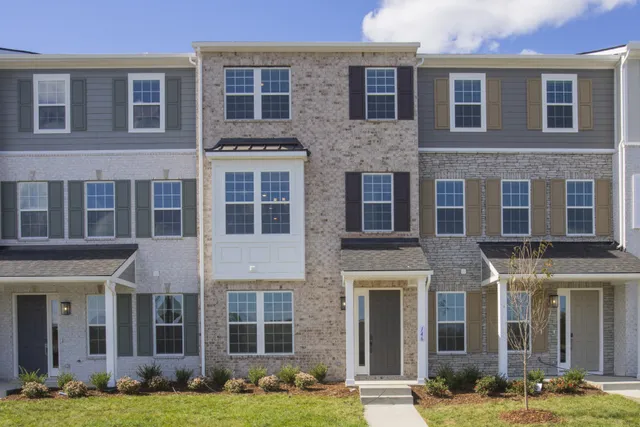 a front view of a brick building with yard