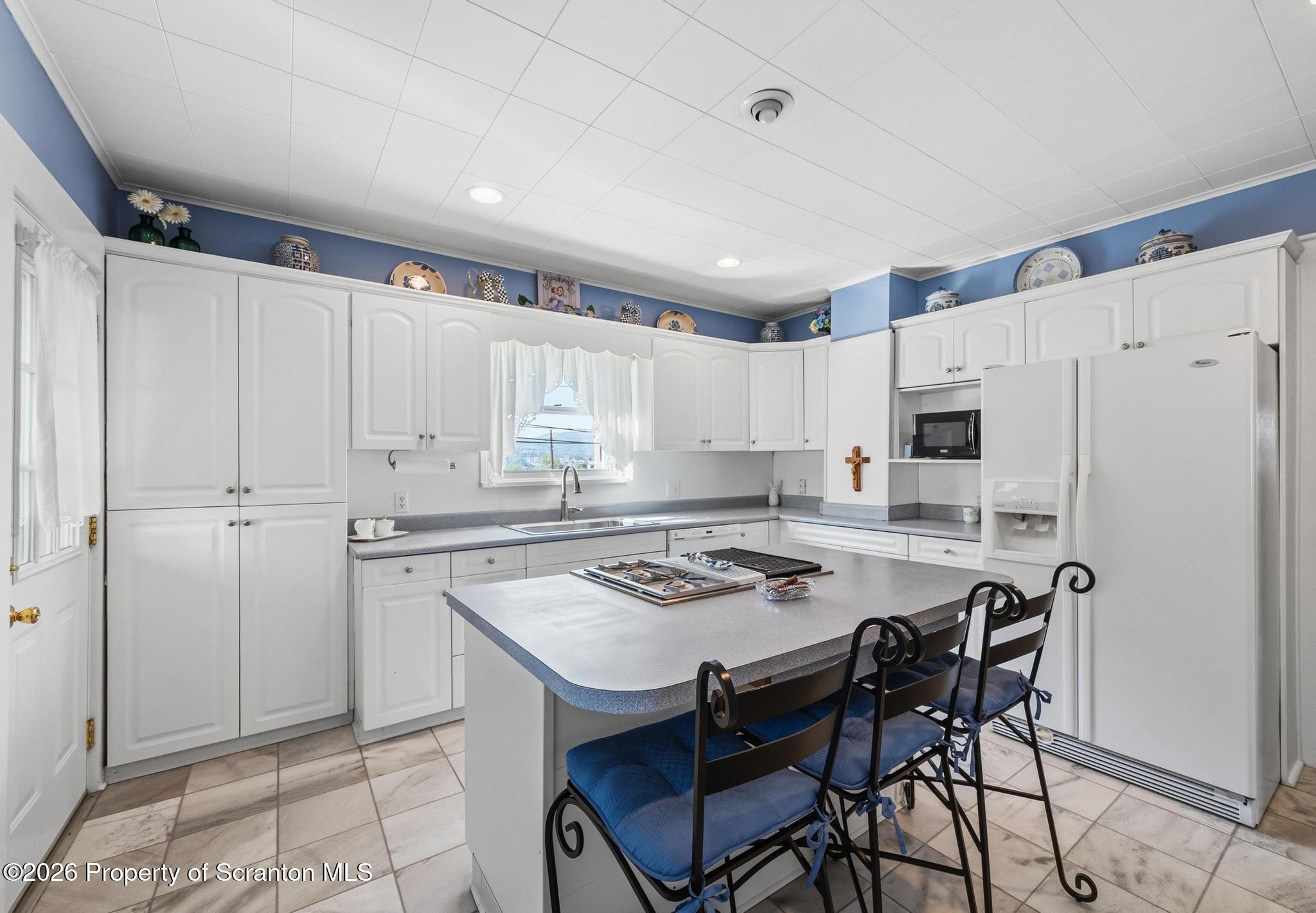 616 Myrtle Street Scranton, PA 18510 - Photo 14 of 65 a kitchen with stainless steel appliances granite countertop a white cabinets and a refrigerator