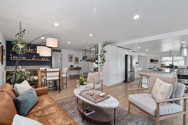 a living room with furniture and kitchen view
