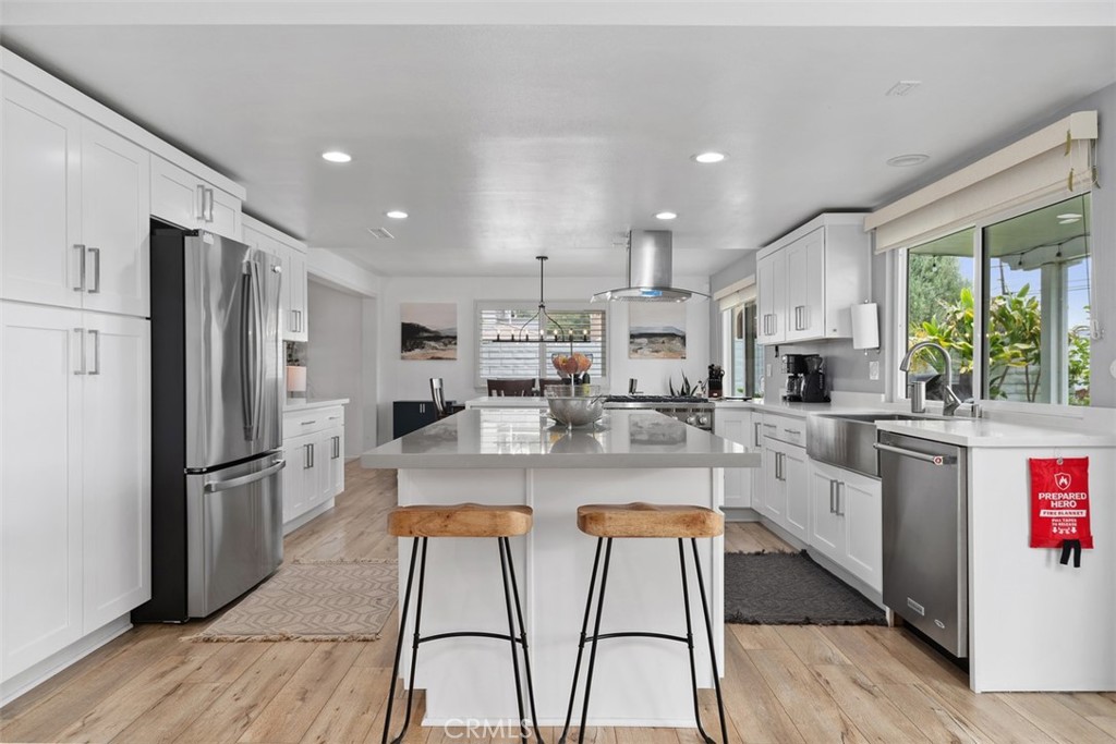 13772 Ridgecrest Circle Tustin, CA 92780 - Photo 14 of 39 a kitchen with stainless steel appliances granite countertop a refrigerator oven a sink dishwasher and white cabinets with wooden floor