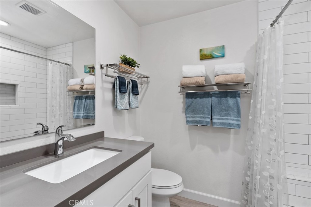 13772 Ridgecrest Circle Tustin, CA 92780 - Photo 30 of 39 a bathroom with a sink toilet and mirror