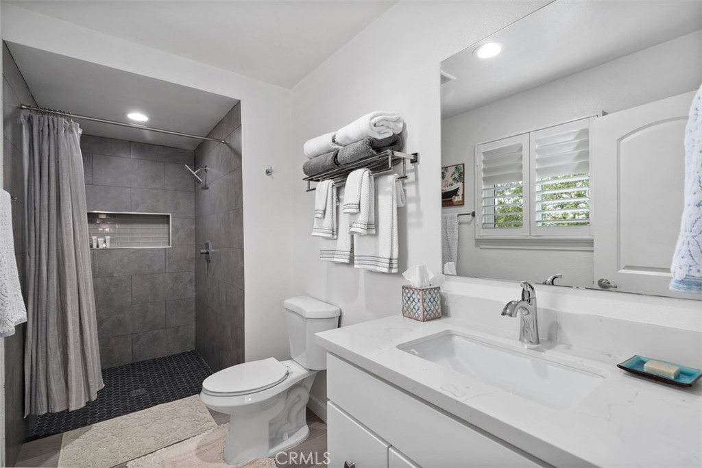 13772 Ridgecrest Circle Tustin, CA 92780 - Photo 32 of 39 a bathroom with a sink toilet and shower