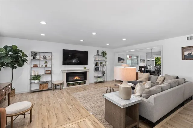 a living room with furniture a fireplace and a potted plant