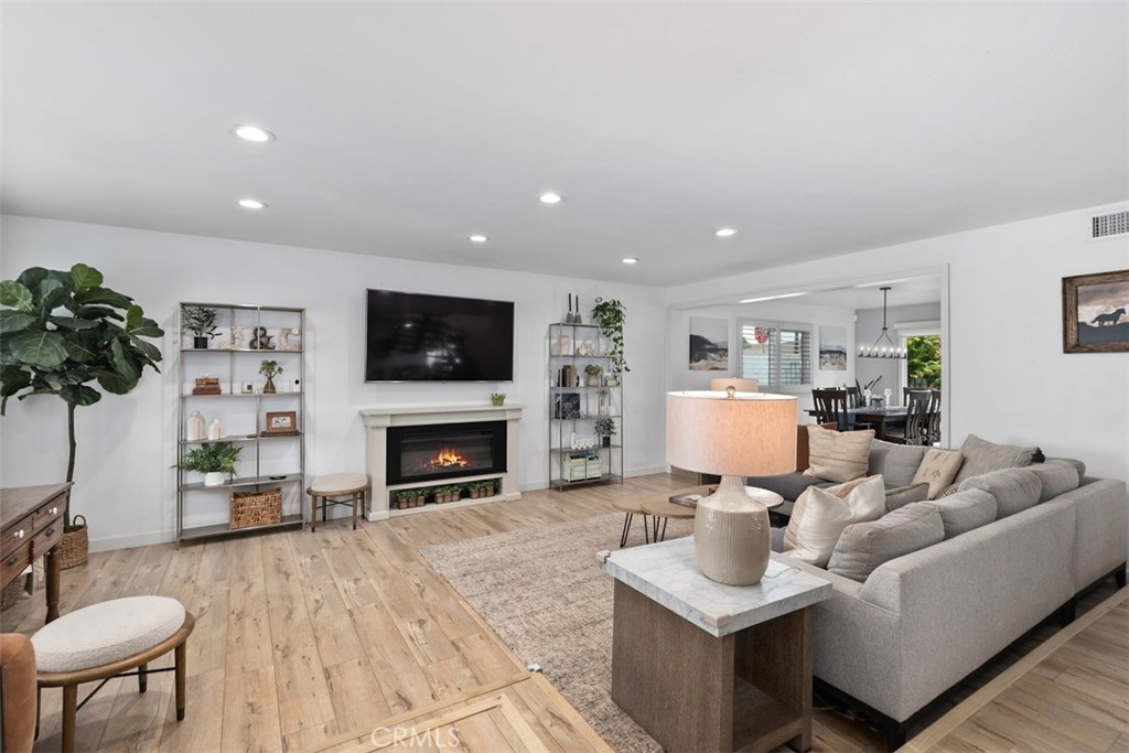13772 Ridgecrest Circle Tustin, CA 92780 - Photo 4 of 39 a living room with furniture a fireplace and a potted plant