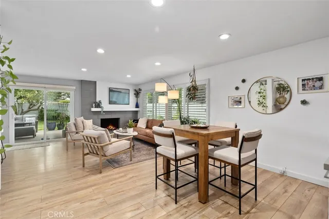 a living room with fireplace furniture and a large window