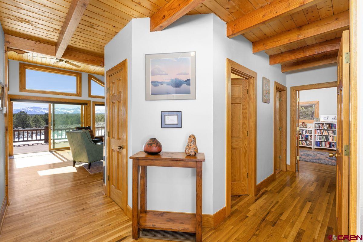 948 Sage Road Montrose, CO 81403 - Photo 1 of 45 a view of a hallway with wooden floor and furniture