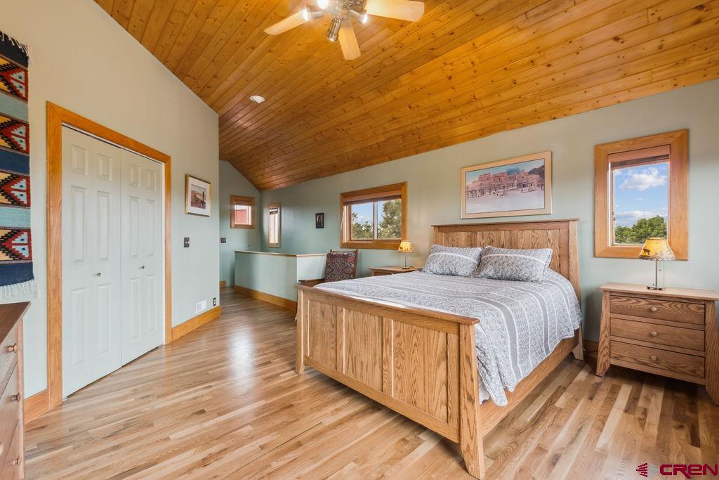 948 Sage Road Montrose, CO 81403 - Photo 12 of 45 a spacious bedroom with a bed and a painting on the wall