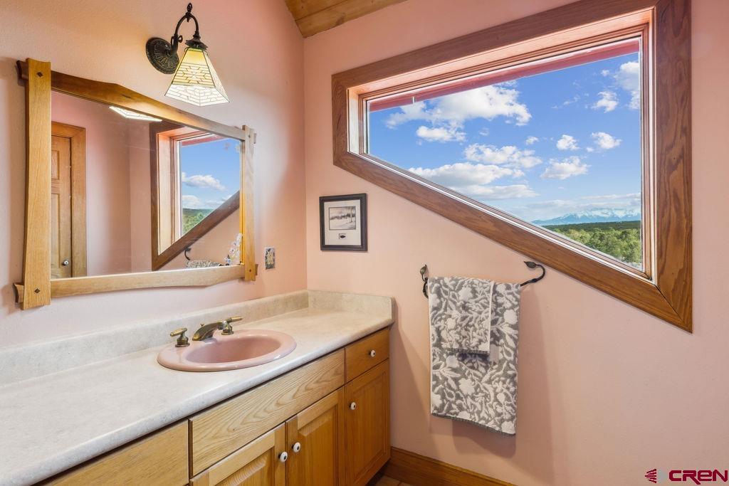 948 Sage Road Montrose, CO 81403 - Photo 13 of 45 a bathroom with a sink and a large mirror