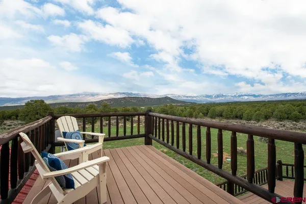 a view of balcony with wooden floor and fence