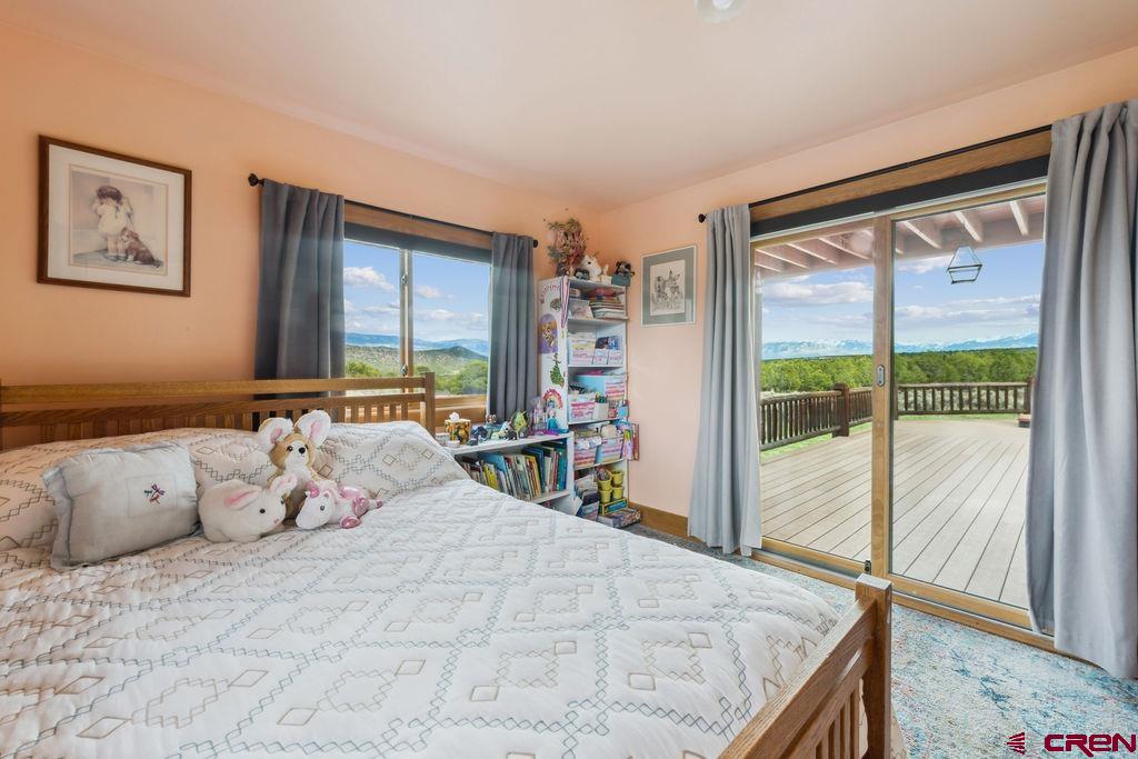 948 Sage Road Montrose, CO 81403 - Photo 17 of 45 a bedroom with a large bed and a large window