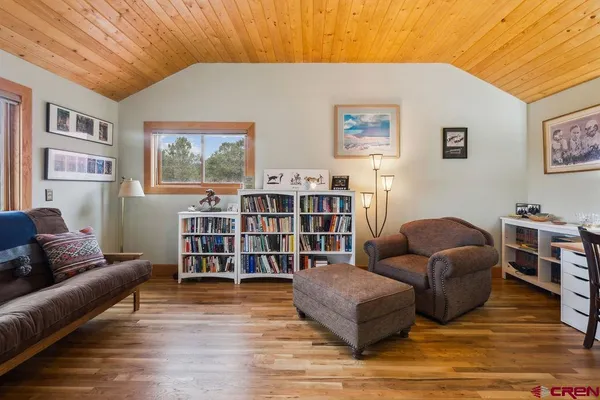 a living room with furniture and a book shelf