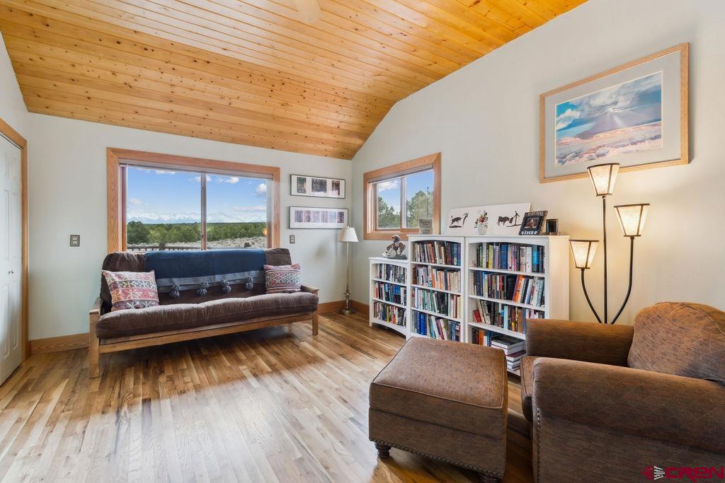 948 Sage Road Montrose, CO 81403 - Photo 19 of 45 a living room with furniture and a book shelf