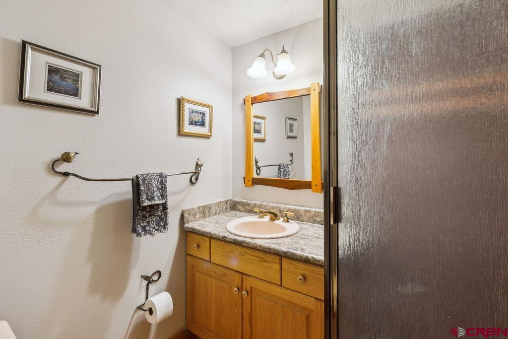 948 Sage Road Montrose, CO 81403 - Photo 21 of 45 a bathroom with a sink a vanity and a mirror