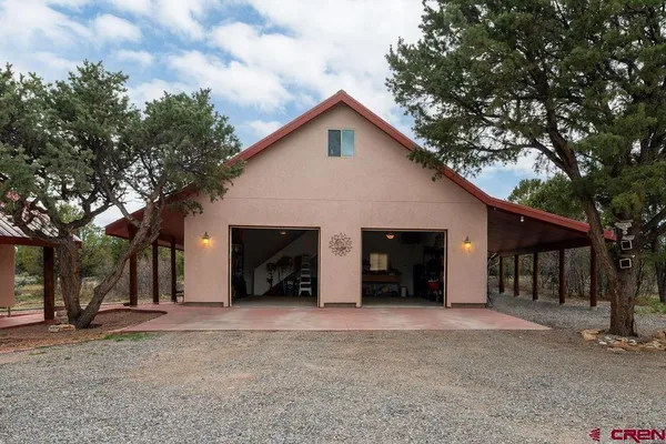 a view of a house with a yard and garage