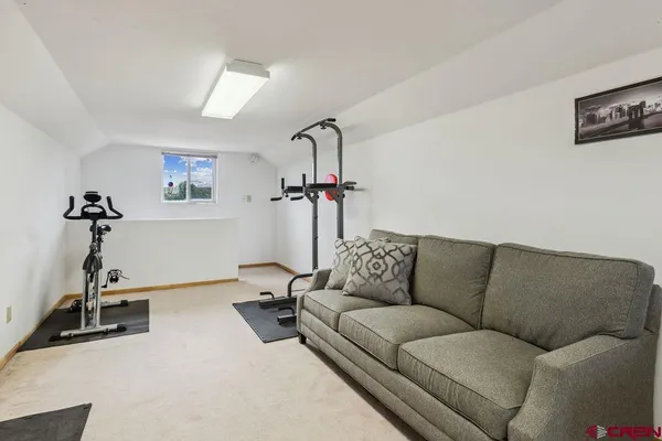 a living room with furniture a flat screen tv and a couch