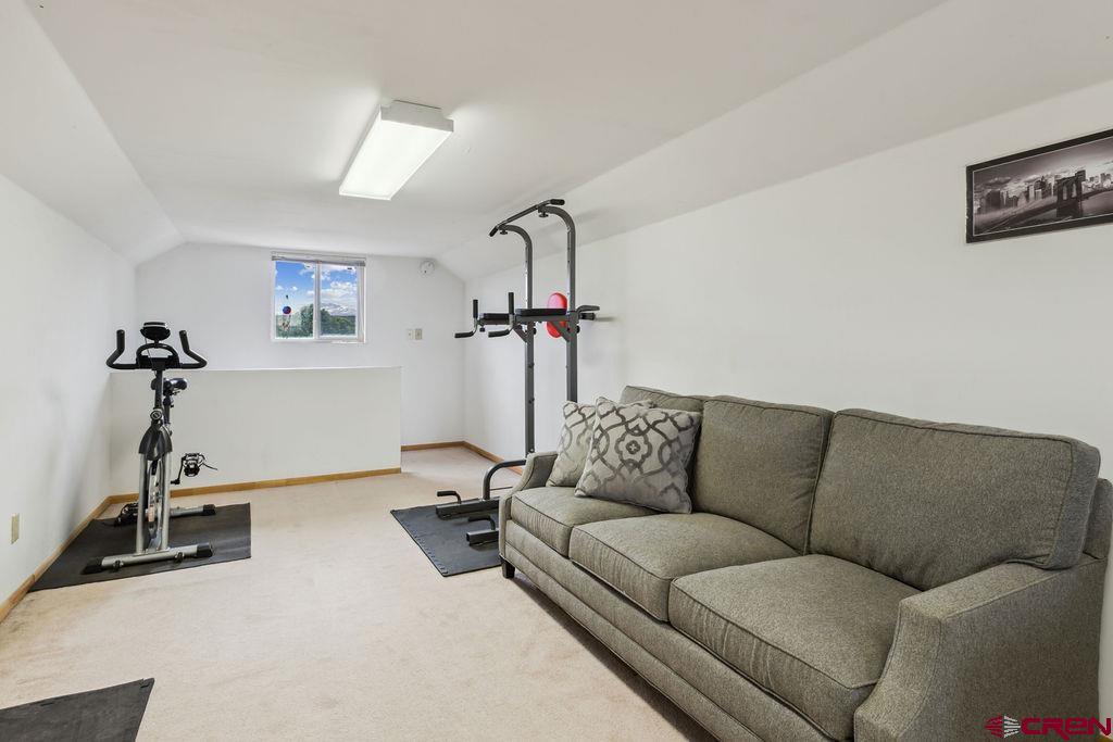 948 Sage Road Montrose, CO 81403 - Photo 27 of 45 a living room with furniture a flat screen tv and a couch