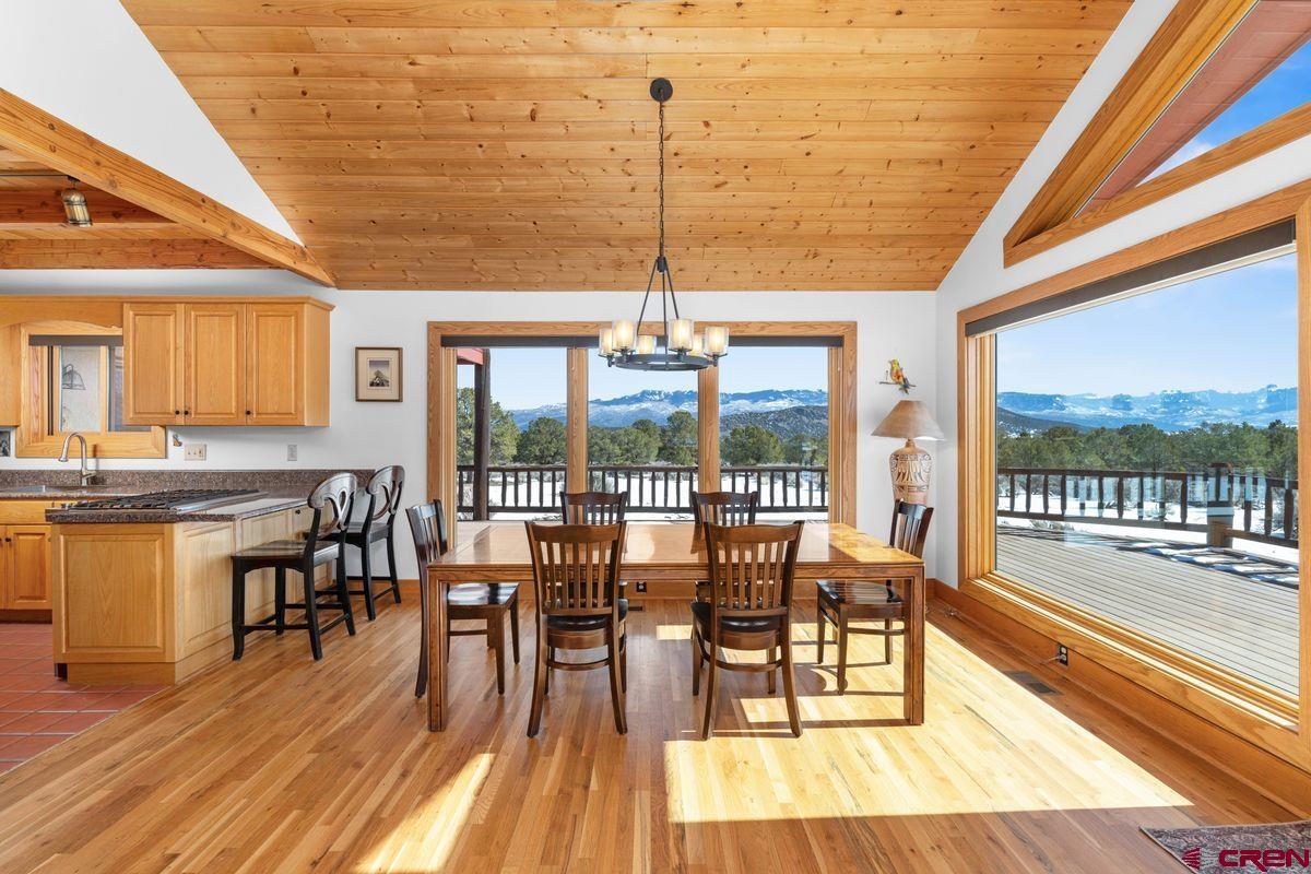 948 Sage Road Montrose, CO 81403 - Photo 42 of 45 a dining room with furniture a chandelier and wooden floor