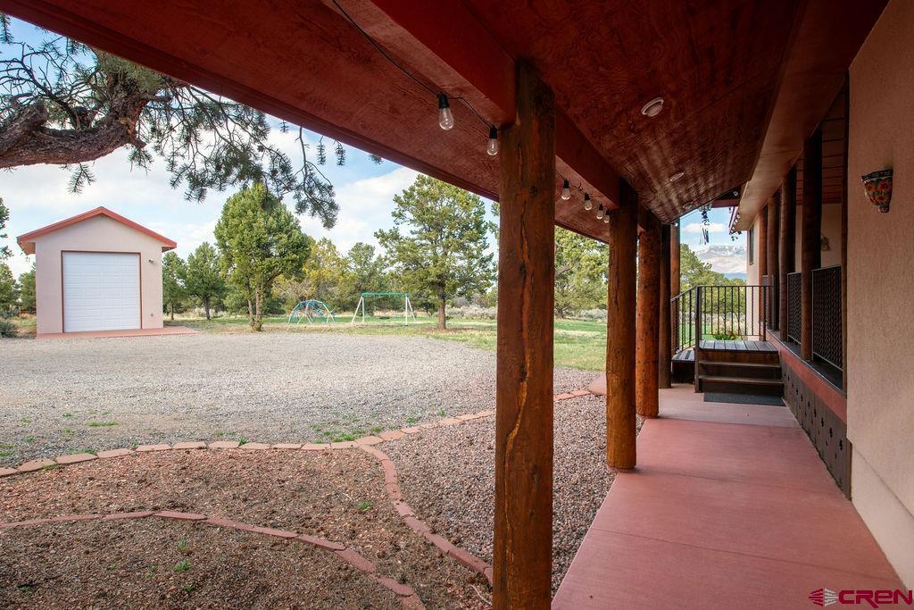 948 Sage Road Montrose, CO 81403 - Photo 43 of 45 a view of backyard with large tree and wooden fence