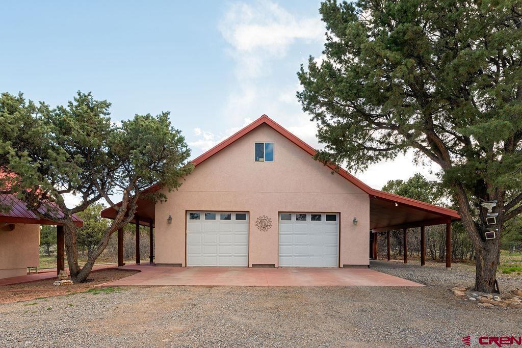 948 Sage Road Montrose, CO 81403 - Photo 45 of 45 a view of a house with a large tree and wooden fence