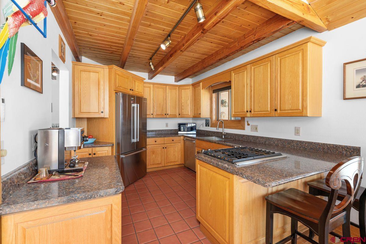 948 Sage Road Montrose, CO 81403 - Photo 6 of 45 a kitchen with stainless steel appliances granite countertop a sink stove and refrigerator