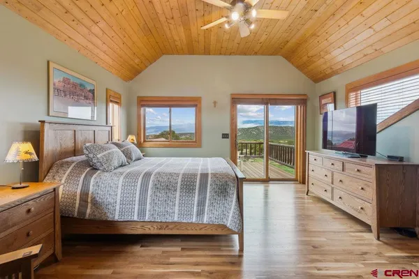 a bedroom with a large bed and a dresser