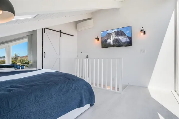a bedroom with a bed and a painting on the wall