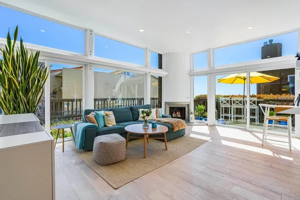 a living room with patio furniture and a large window