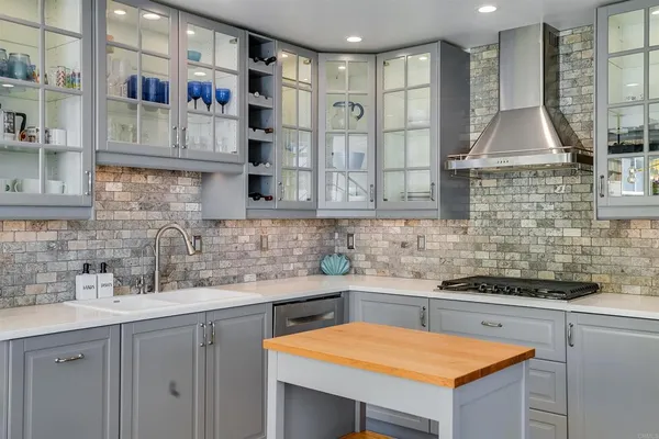 a kitchen with stainless steel appliances a sink stove and cabinets