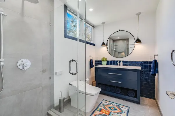 a bathroom with a toilet a sink and mirror