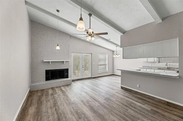 a view of a kitchen with a sink and a stove top oven