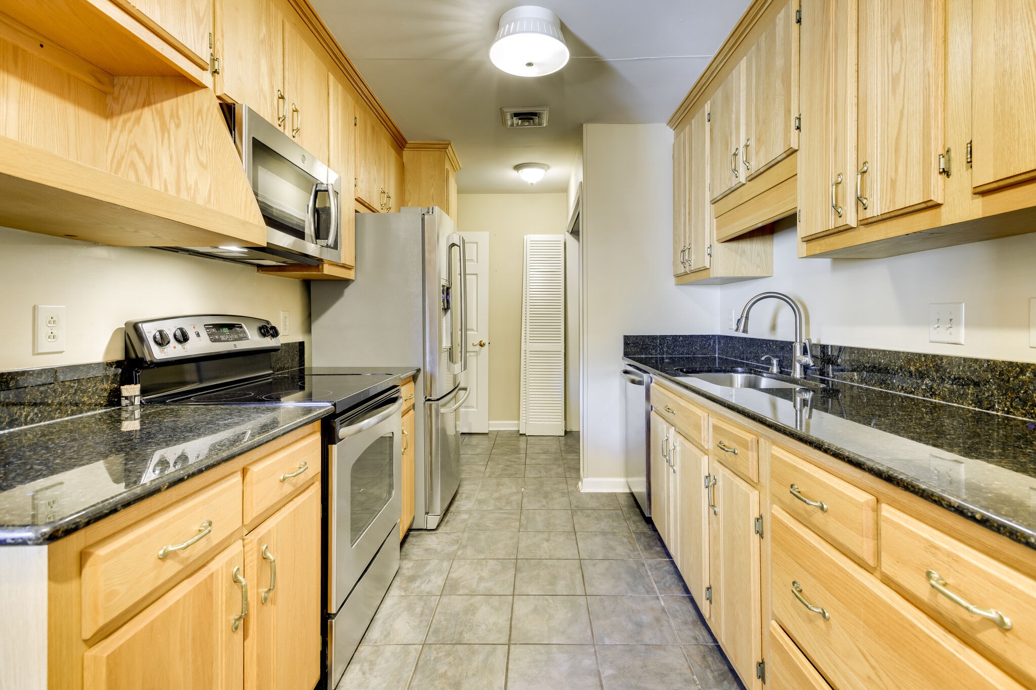 1126 General George Patton Road Nashville, TN 37221 - Photo 13 of 28 a kitchen with stainless steel appliances granite countertop a sink and cabinets