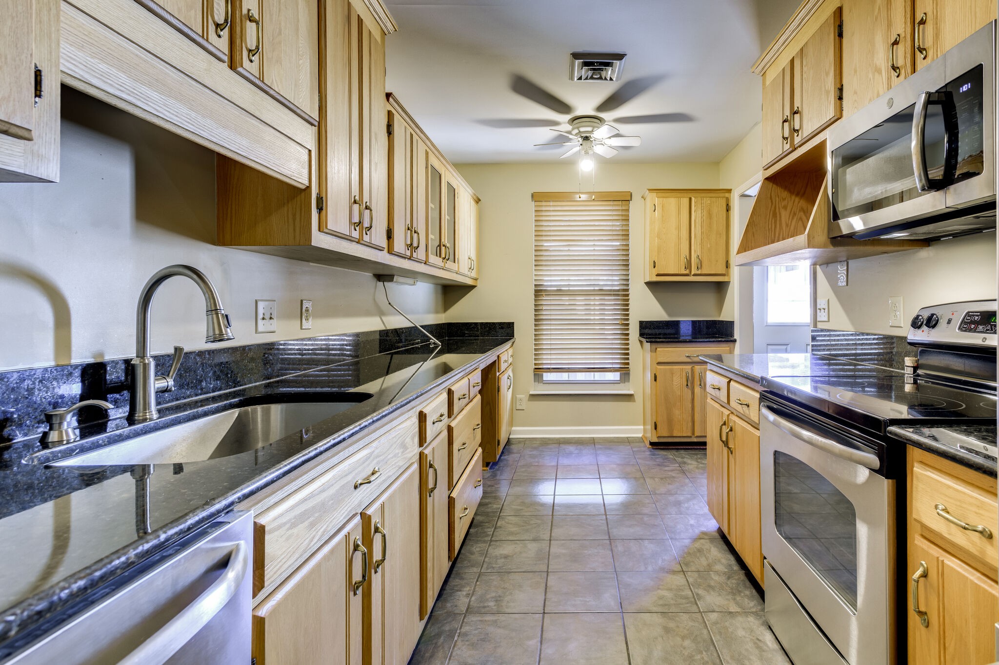 1126 General George Patton Road Nashville, TN 37221 - Photo 14 of 28 a kitchen with stainless steel appliances a sink a stove and cabinets