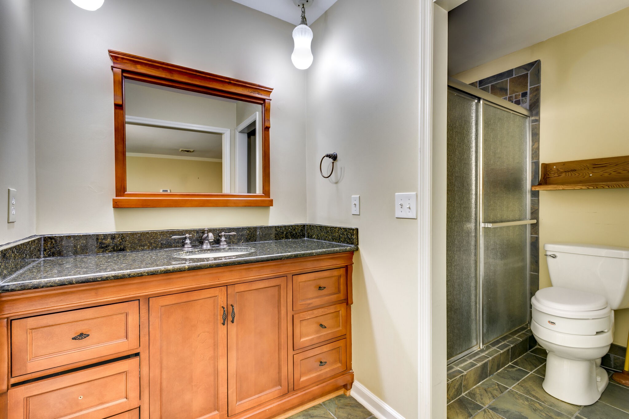 1126 General George Patton Road Nashville, TN 37221 - Photo 25 of 28 a bathroom with a granite countertop sink and a mirror