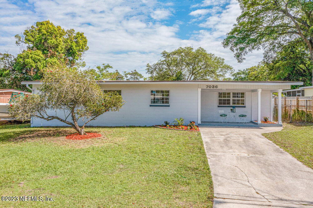 7036 Camelot Road Jacksonville, FL 32211 - Photo 1 of 27 a backyard of a house with table and chairs