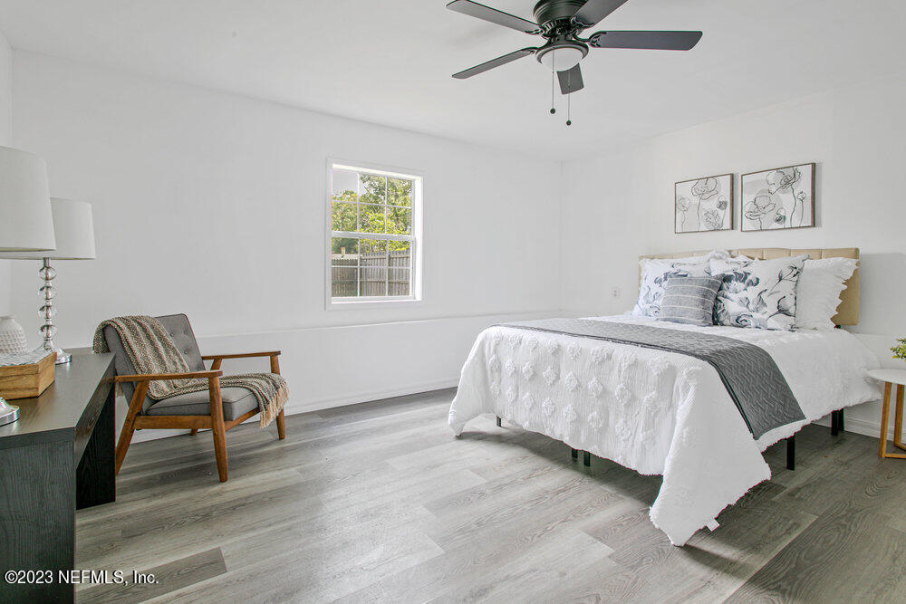 7036 Camelot Road Jacksonville, FL 32211 - Photo 15 of 27 a bedroom with a bed and a chair