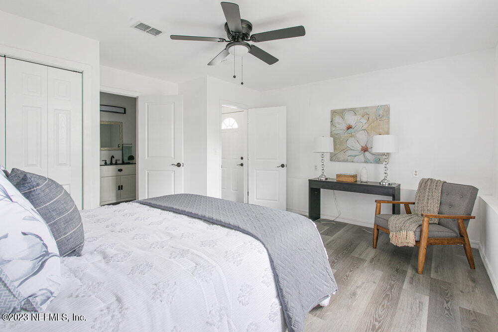 7036 Camelot Road Jacksonville, FL 32211 - Photo 16 of 27 a spacious bedroom with a bed and a table