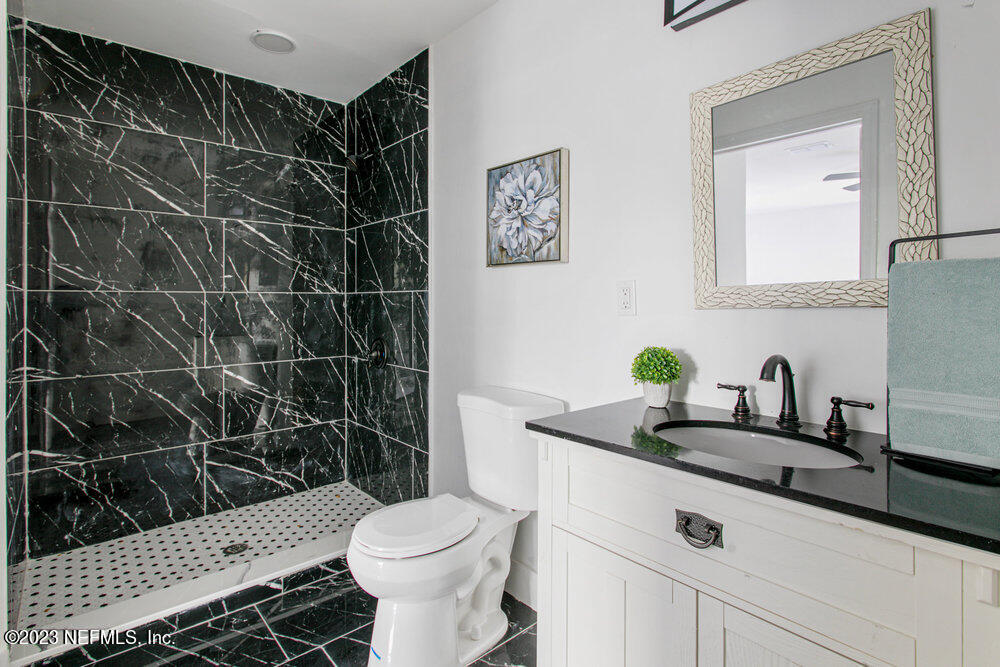 7036 Camelot Road Jacksonville, FL 32211 - Photo 17 of 27 a bathroom with a sink toilet and shower