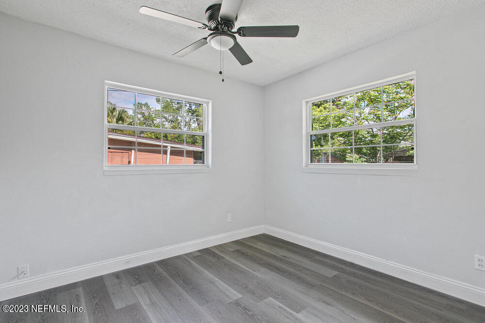 7036 Camelot Road Jacksonville, FL 32211 - Photo 18 of 27 a view of empty room with wooden floor and fan