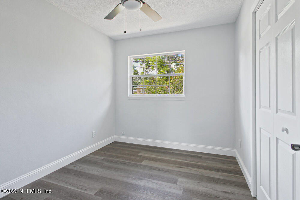 7036 Camelot Road Jacksonville, FL 32211 - Photo 23 of 27 a view of an empty room with wooden floor and a window