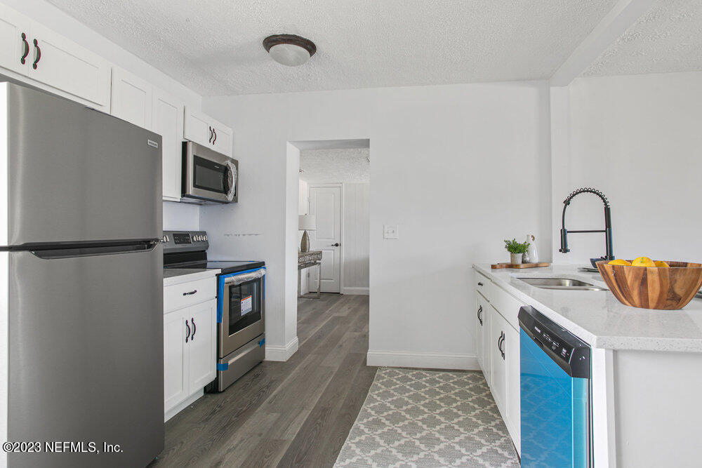 7036 Camelot Road Jacksonville, FL 32211 - Photo 10 of 27 a kitchen with a refrigerator stove and sink