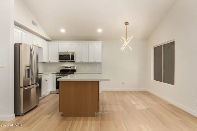 a kitchen with wooden cabinets and stainless steel appliances