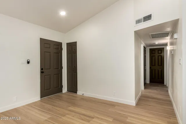 a view of an empty room with wooden floor