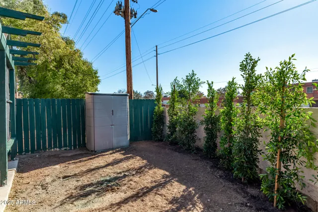 a backyard of a house with table and chairs