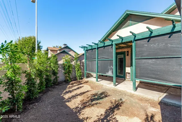 a view of a patio with table and chairs with wooden floor and fence