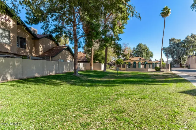 a view of a house with small yard plants and a garage