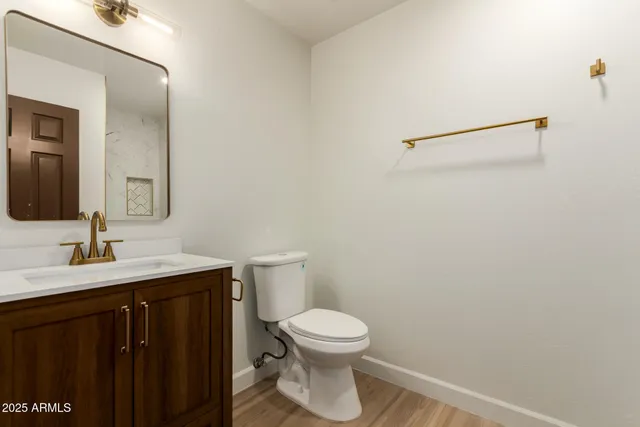 a bathroom with a toilet a sink and mirror