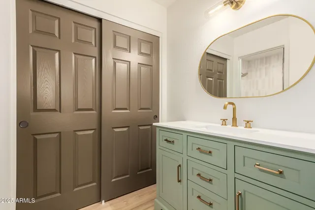 a bathroom with a mirror and a sink
