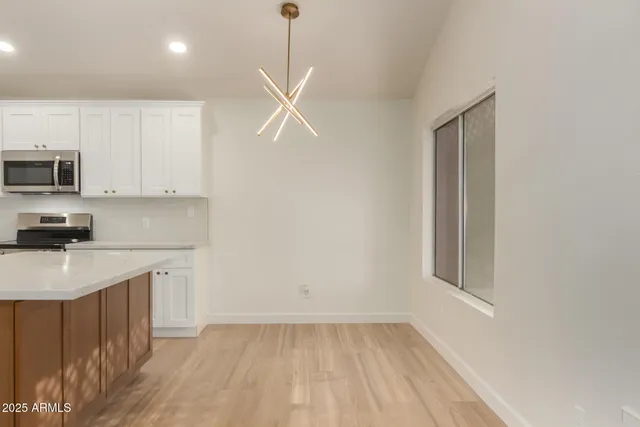 a kitchen with a sink a window and stainless steel appliances